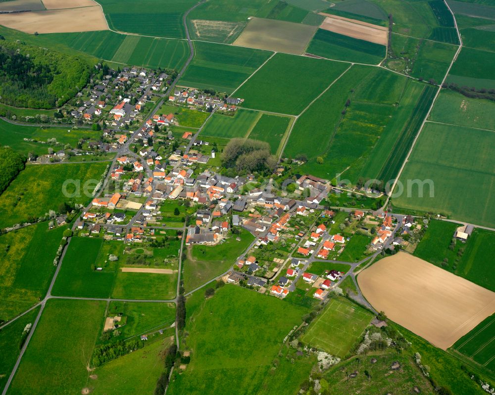 Aerial image Liederbach - Agricultural land and field boundaries surround the settlement area of the village in Liederbach in the state Hesse, Germany