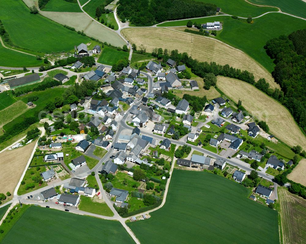 Liederbach from above - Agricultural land and field boundaries surround the settlement area of the village in Liederbach in the state Rhineland-Palatinate, Germany