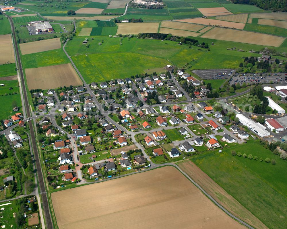 Lindenstruth from above - Agricultural land and field boundaries surround the settlement area of the village in Lindenstruth in the state Hesse, Germany