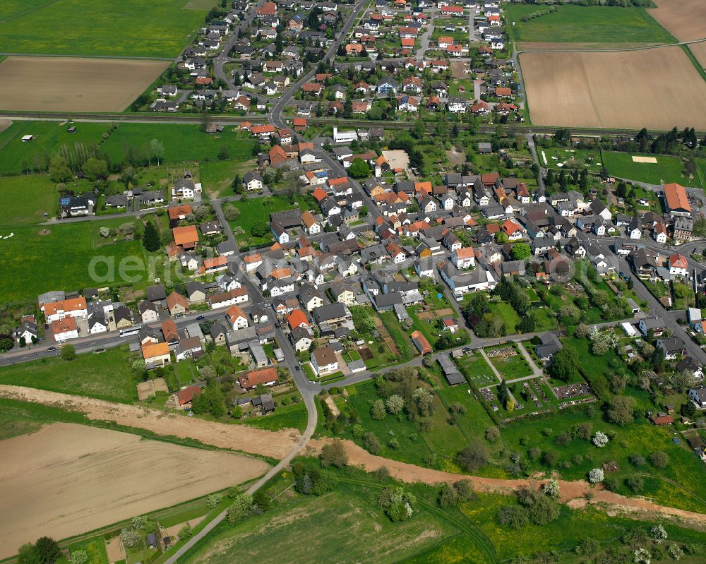 Lindenstruth from the bird's eye view: Agricultural land and field boundaries surround the settlement area of the village in Lindenstruth in the state Hesse, Germany