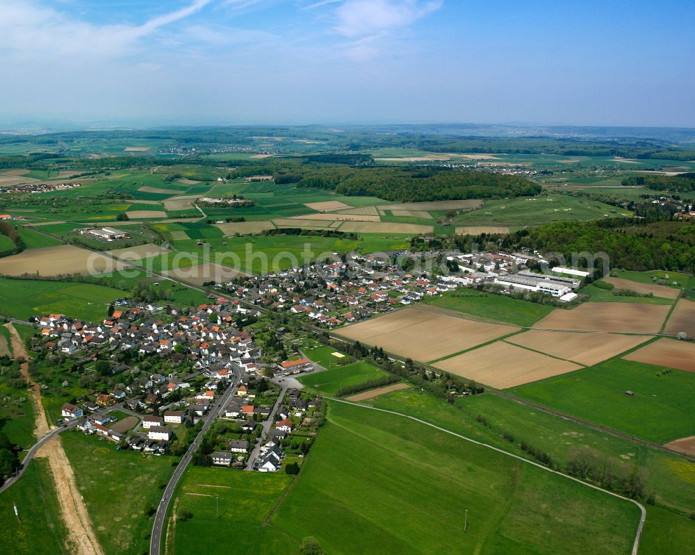 Lindenstruth from the bird's eye view: Agricultural land and field boundaries surround the settlement area of the village in Lindenstruth in the state Hesse, Germany