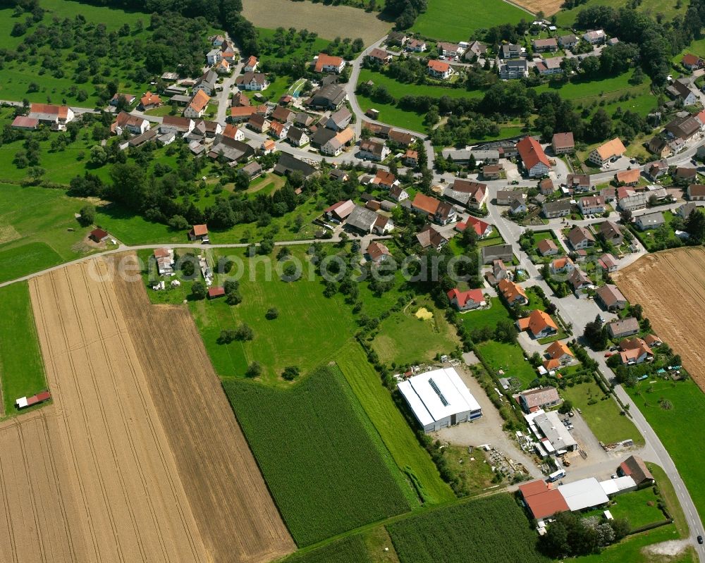 Ölkofen from above - Agricultural land and field boundaries surround the settlement area of the village in Ölkofen in the state Baden-Wuerttemberg, Germany