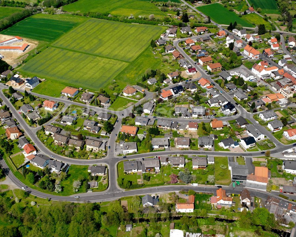 Londorf from above - Agricultural land and field boundaries surround the settlement area of the village in Londorf in the state Hesse, Germany