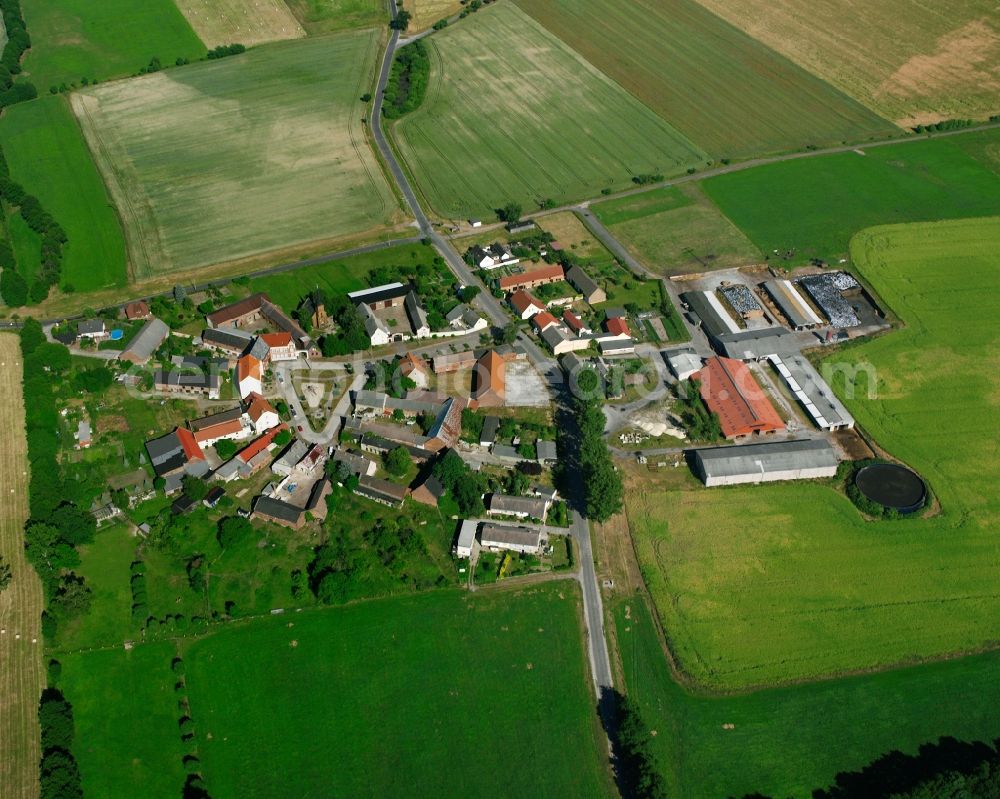 Luso from above - Agricultural land and field boundaries surround the settlement area of the village in Luso in the state Saxony-Anhalt, Germany