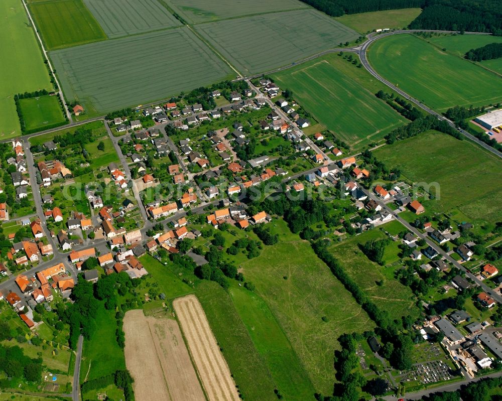 Aerial photograph Lutterberg - Agricultural land and field boundaries surround the settlement area of the village in Lutterberg in the state Lower Saxony, Germany