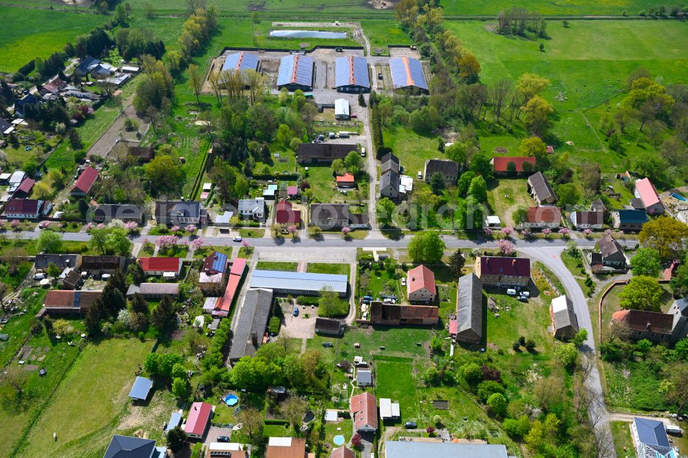 Manker from above - Agricultural land and field boundaries surround the settlement area of the village in Manker in the state Brandenburg, Germany