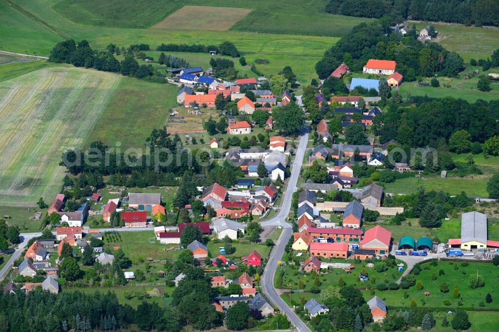 Aerial image Mankmuß - Agricultural land and field boundaries surround the settlement area of the village in Mankmuss in the state Brandenburg, Germany