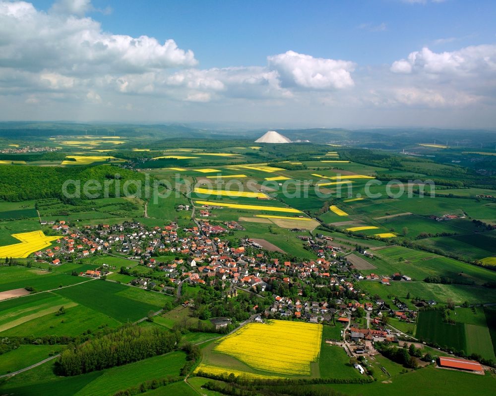 Mansbach from above - Agricultural land and field boundaries surround the settlement area of the village in Mansbach in the state Hesse, Germany