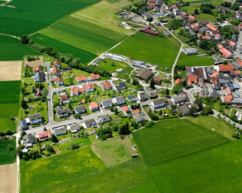 Aerial image Maulbach - Agricultural land and field boundaries surround the settlement area of the village in Maulbach in the state Hesse, Germany