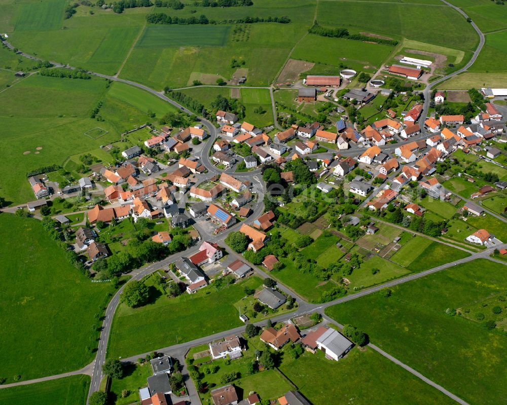 Meiches from the bird's eye view: Agricultural land and field boundaries surround the settlement area of the village in Meiches in the state Hesse, Germany