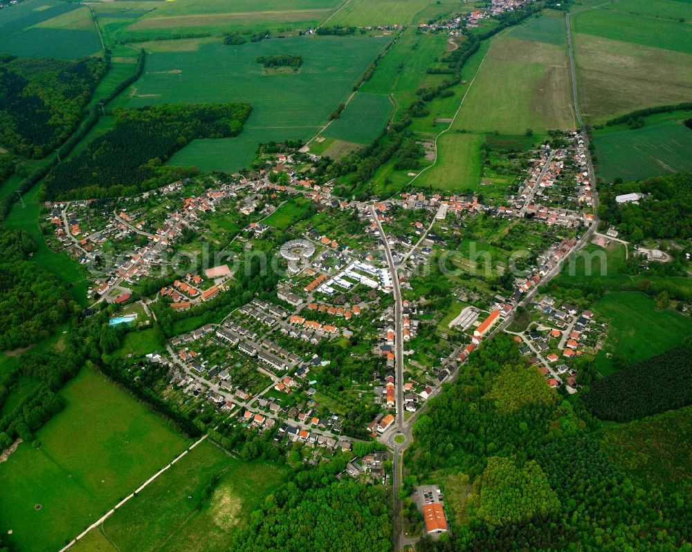 Meinsdorf from above - Agricultural land and field boundaries surround the settlement area of the village in Meinsdorf in the state Saxony-Anhalt, Germany