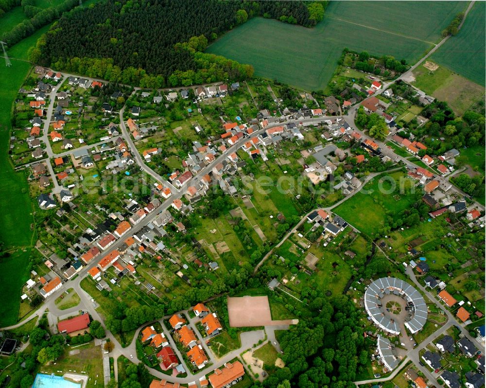 Meinsdorf from above - Agricultural land and field boundaries surround the settlement area of the village in Meinsdorf in the state Saxony-Anhalt, Germany