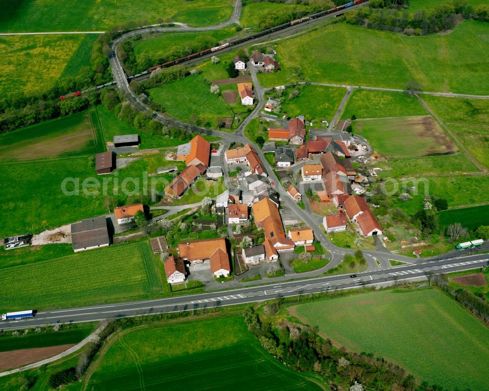 Meisenbach from above - Agricultural land and field boundaries surround the settlement area of the village in Meisenbach in the state Hesse, Germany