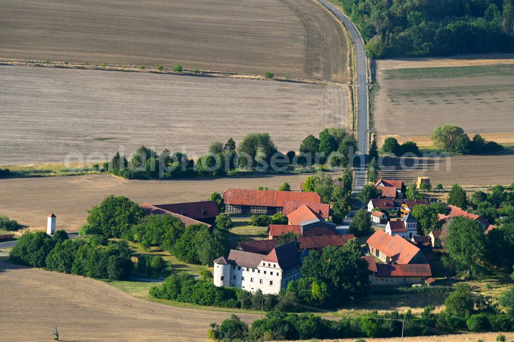 Mellrichstadt from the bird's eye view: Agricultural land and field boundaries surround the settlement area of the village in Mellrichstadt in the state Bavaria, Germany