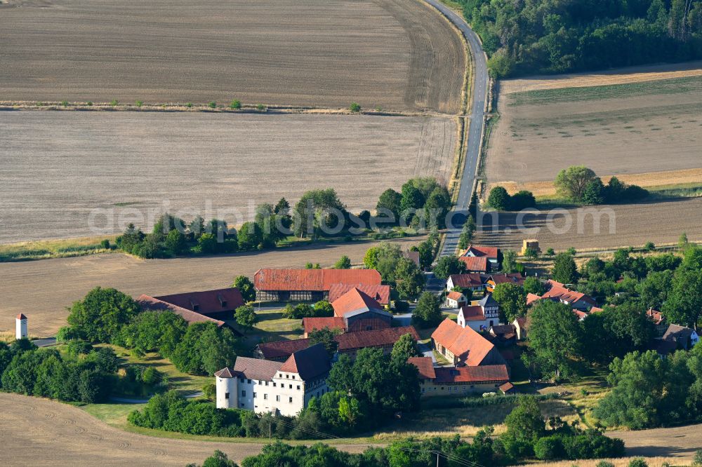 Aerial image Mellrichstadt - Agricultural land and field boundaries surround the settlement area of the village in Mellrichstadt in the state Bavaria, Germany