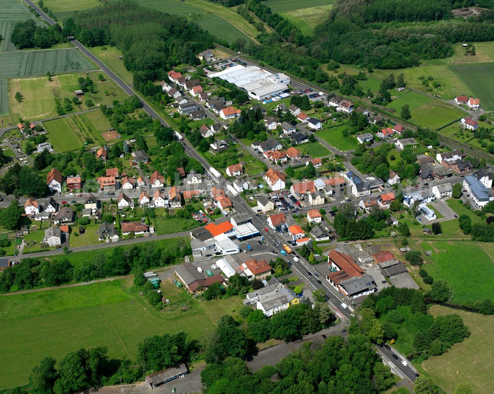 Merlau from the bird's eye view: Agricultural land and field boundaries surround the settlement area of the village in Merlau in the state Hesse, Germany