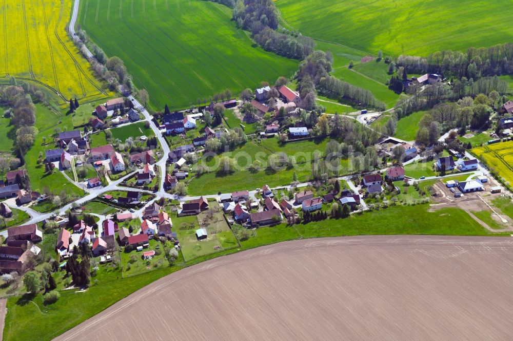 Meschwitz from above - Agricultural land and field boundaries surround the settlement area of the village in Meschwitz in the state Saxony, Germany