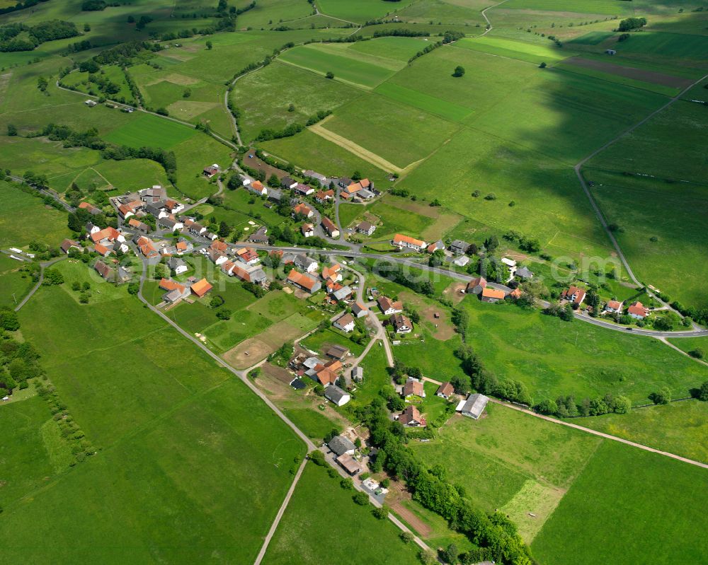 Aerial photograph Metzlos-Gehaag - Agricultural land and field boundaries surround the settlement area of the village in Metzlos-Gehaag in the state Hesse, Germany