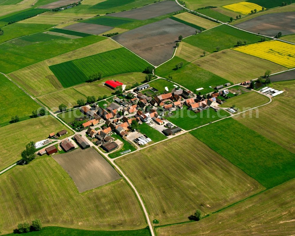 Aerial photograph Meuchlein - Agricultural land and field boundaries surround the settlement area of the village in Meuchlein in the state Bavaria, Germany