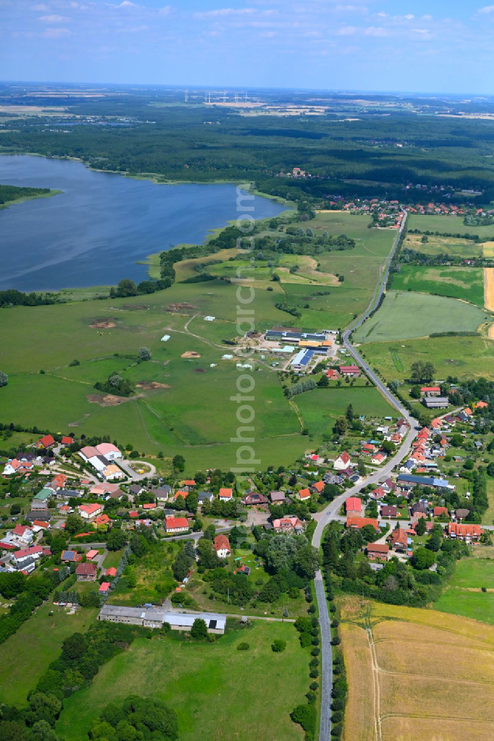 Aerial photograph Mühl Rosin - Agricultural land and field boundaries surround the settlement area of the village in Mühl Rosin in the state Mecklenburg - Western Pomerania, Germany