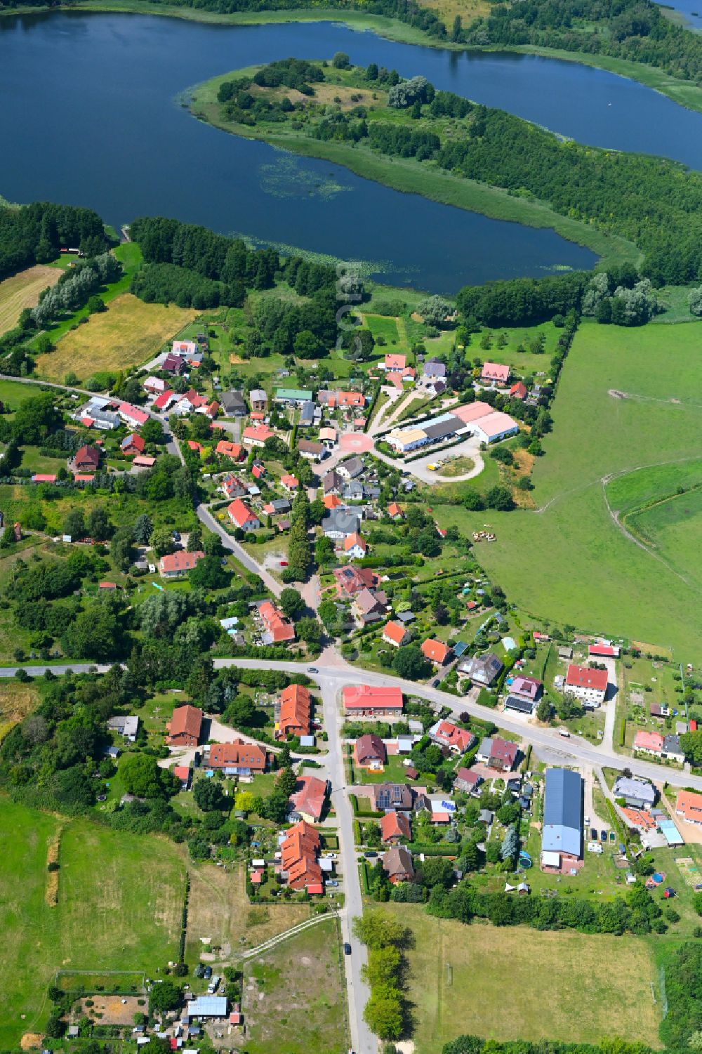 Aerial image Mühl Rosin - Agricultural land and field boundaries surround the settlement area of the village in Mühl Rosin in the state Mecklenburg - Western Pomerania, Germany