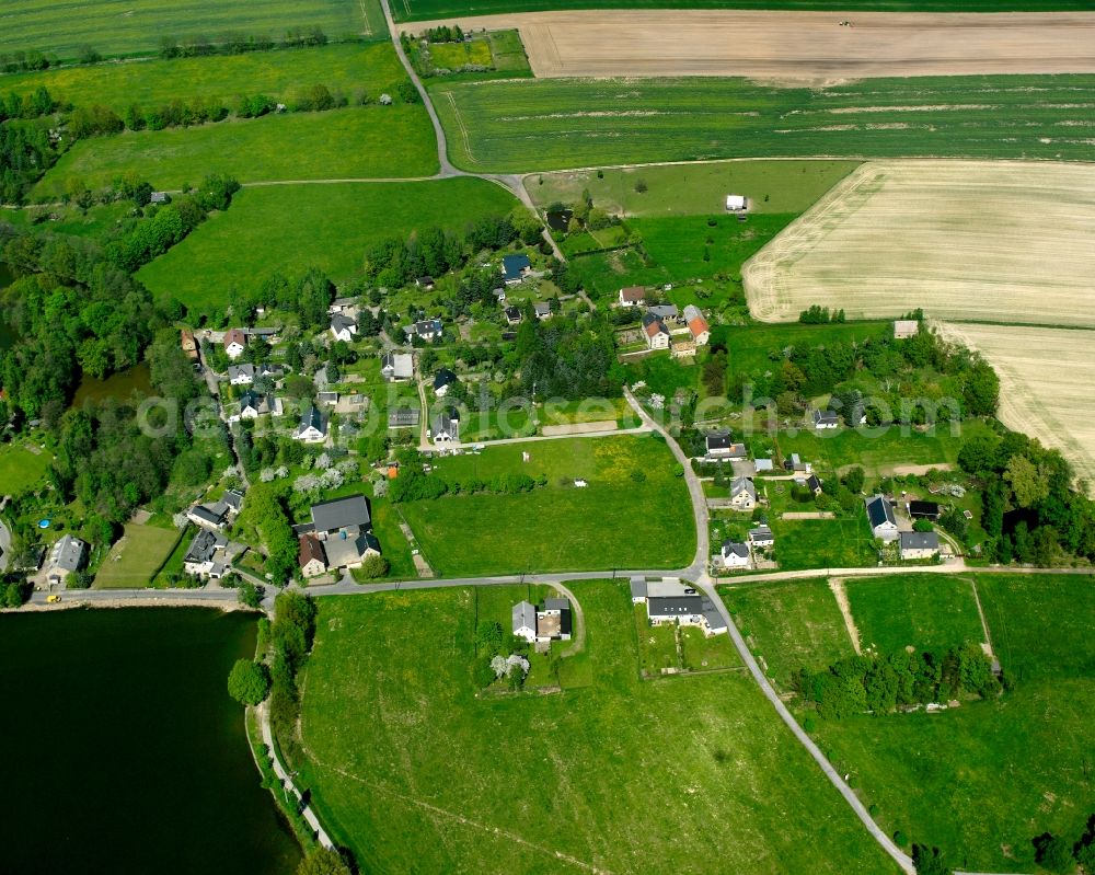 Mühlau from above - Agricultural land and field boundaries surround the settlement area of the village in Mühlau in the state Saxony, Germany