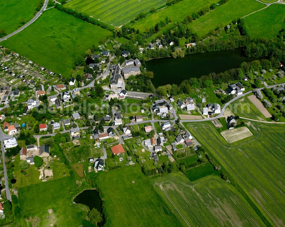 Mühlau from the bird's eye view: Agricultural land and field boundaries surround the settlement area of the village in Mühlau in the state Saxony, Germany