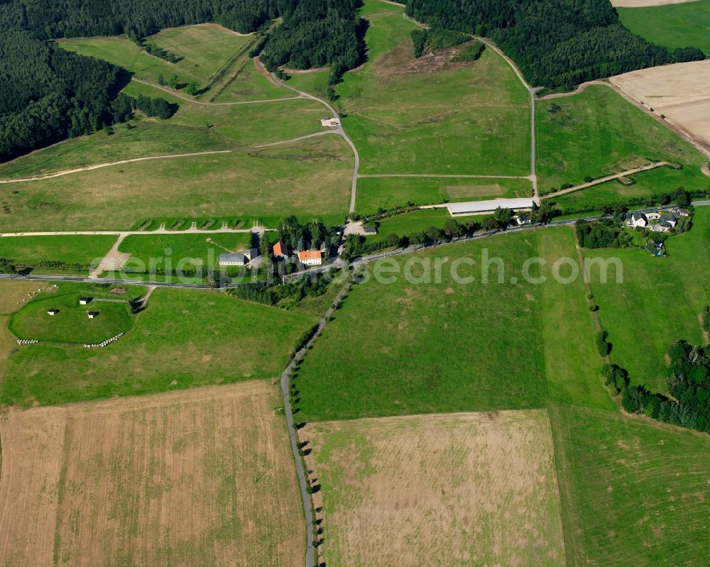 Mühlbach from above - Agricultural land and field boundaries surround the settlement area of the village in Mühlbach in the state Saxony, Germany