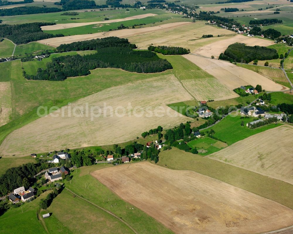 Mühlbach from the bird's eye view: Agricultural land and field boundaries surround the settlement area of the village in Mühlbach in the state Saxony, Germany