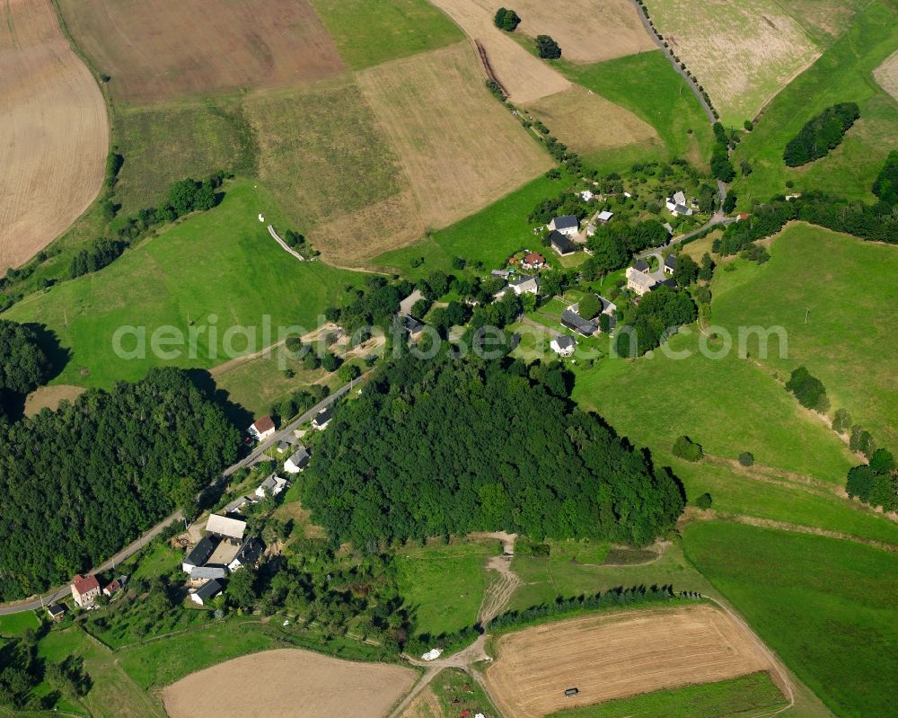 Aerial image Mühlbach - Agricultural land and field boundaries surround the settlement area of the village in Mühlbach in the state Saxony, Germany