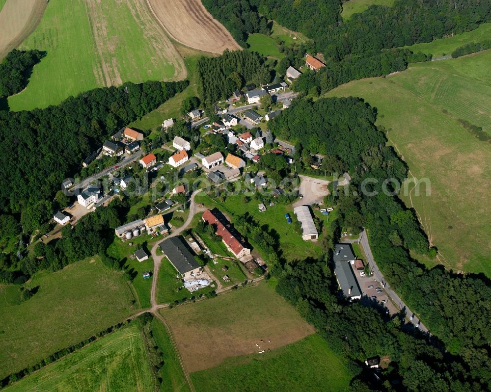 Mühlbach from above - Agricultural land and field boundaries surround the settlement area of the village in Mühlbach in the state Saxony, Germany