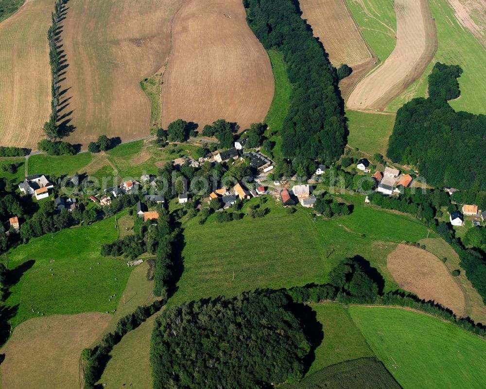 Mühlbach from the bird's eye view: Agricultural land and field boundaries surround the settlement area of the village in Mühlbach in the state Saxony, Germany