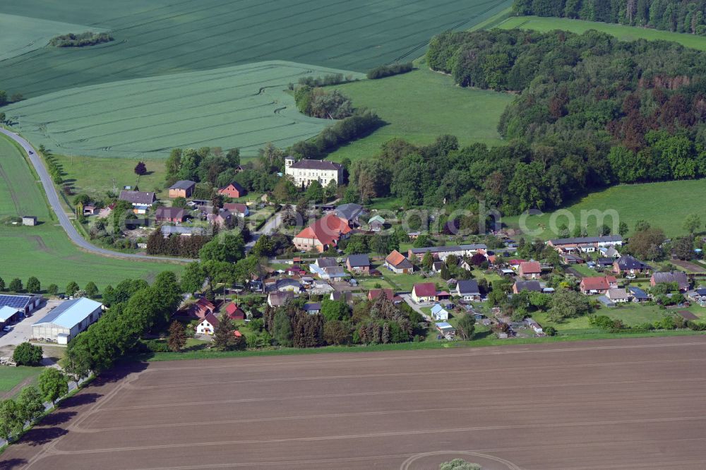 Mühlenbeck from the bird's eye view: Agricultural land and field boundaries surround the settlement area of the village in Muehlenbeck in the state Mecklenburg - Western Pomerania, Germany