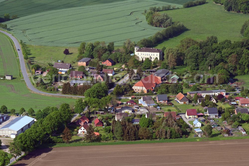 Aerial image Mühlenbeck - Agricultural land and field boundaries surround the settlement area of the village in Muehlenbeck in the state Mecklenburg - Western Pomerania, Germany