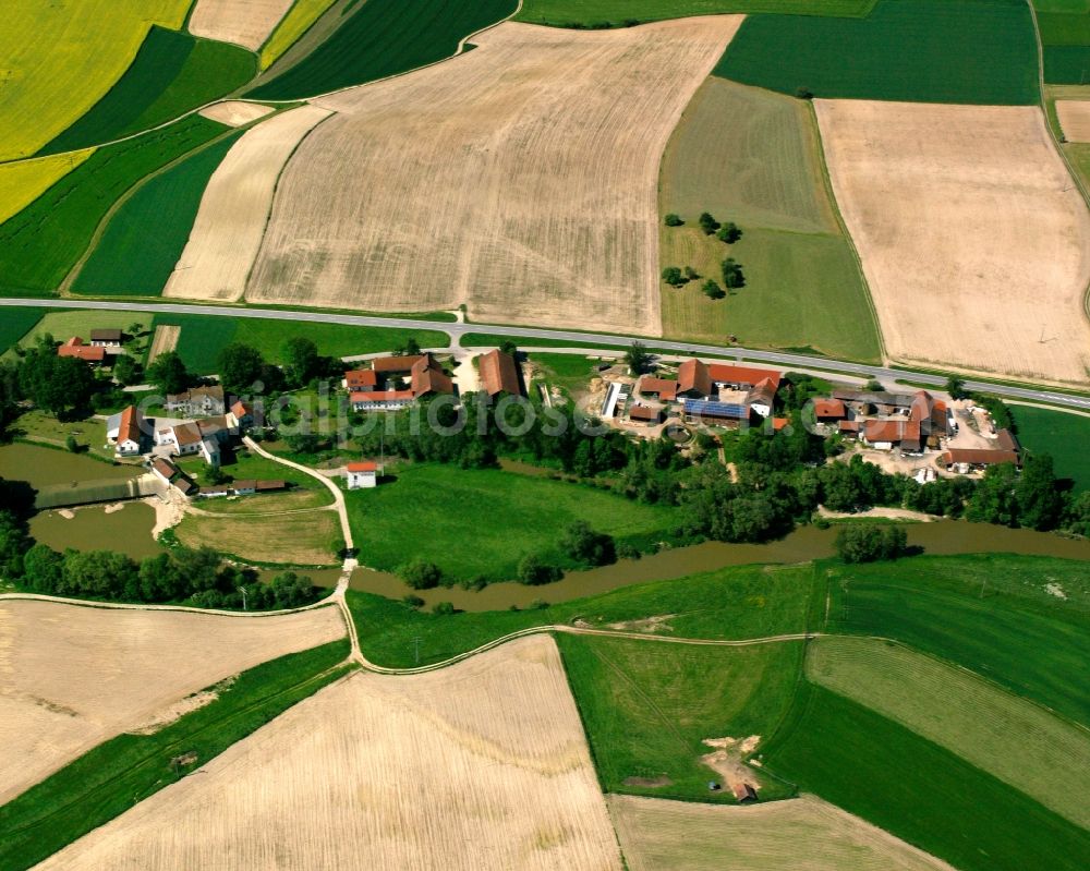 Mühlham from above - Agricultural land and field boundaries surround the settlement area of the village in Mühlham in the state Bavaria, Germany