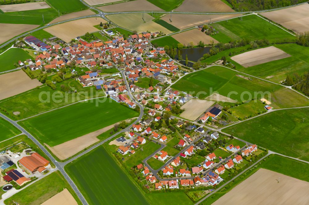 Michelfeld from the bird's eye view: Agricultural land and field boundaries surround the settlement area of the village in Michelfeld in the state Bavaria, Germany