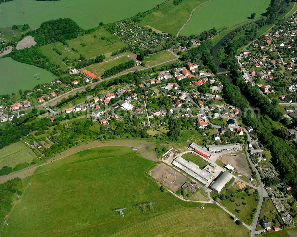 Mildenfurth from above - Agricultural land and field boundaries surround the settlement area of the village in Mildenfurth in the state Thuringia, Germany