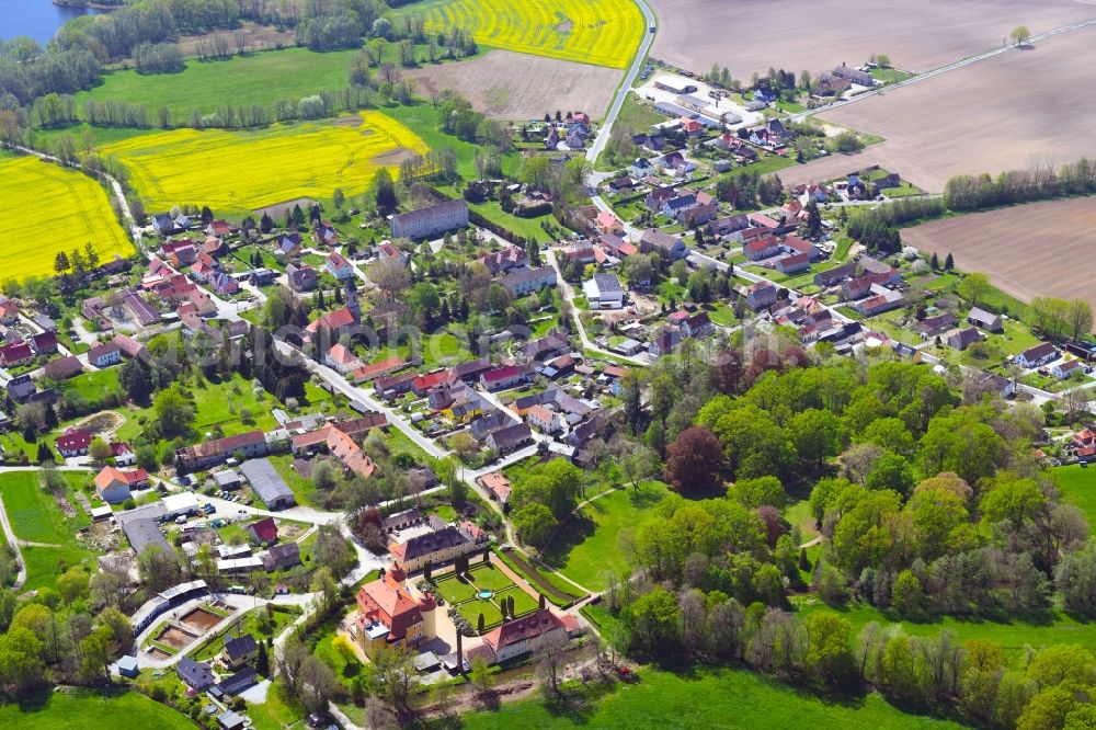 Aerial image Milkel - Agricultural land and field boundaries surround the settlement area of the village in Milkel in the state Saxony, Germany