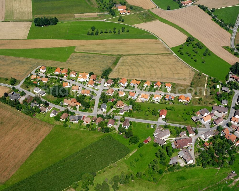 Mindersdorf from above - Agricultural land and field boundaries surround the settlement area of the village in Mindersdorf in the state Baden-Wuerttemberg, Germany