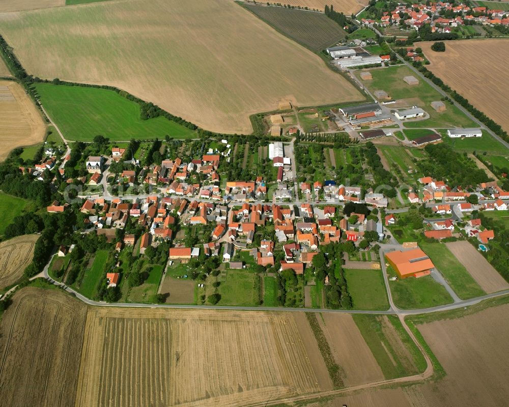 Aerial image Mittelsömmern - Agricultural land and field boundaries surround the settlement area of the village in Mittelsömmern in the state Thuringia, Germany