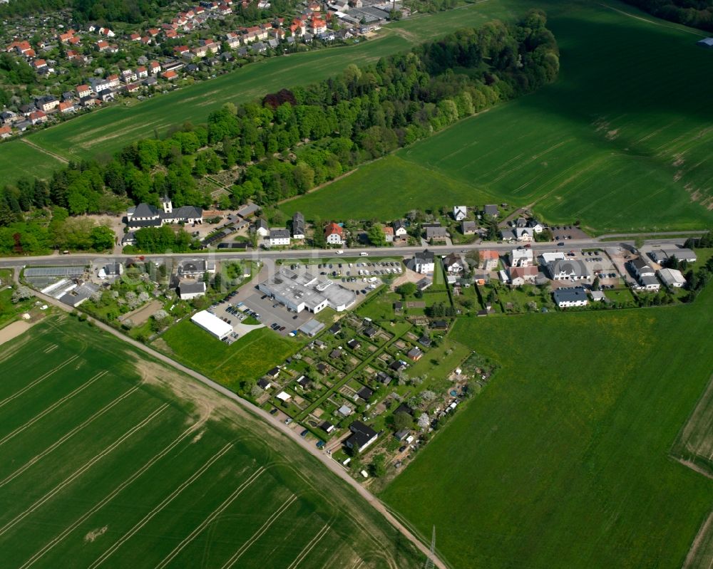 Mittweida from above - Agricultural land and field boundaries surround the settlement area of the village in Mittweida in the state Saxony, Germany