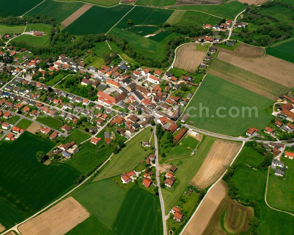 Münchsdorf from above - Agricultural land and field boundaries surround the settlement area of the village in Münchsdorf in the state Bavaria, Germany