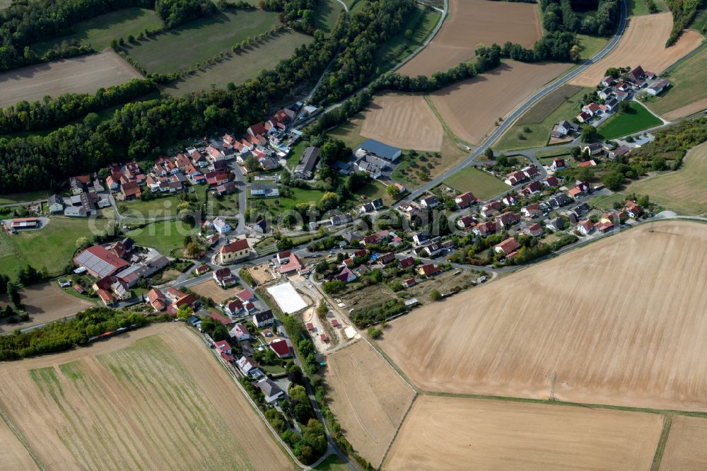 Münster from the bird's eye view: Agricultural land and field boundaries surround the settlement area of the village in Münster in the state Bavaria, Germany