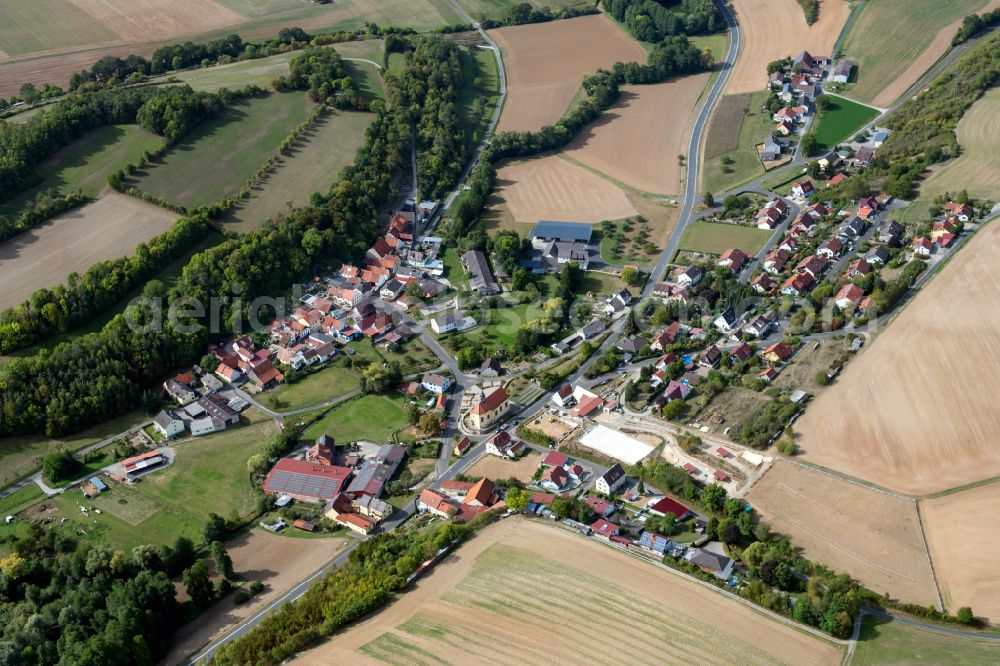 Aerial photograph Münster - Agricultural land and field boundaries surround the settlement area of the village in Münster in the state Bavaria, Germany