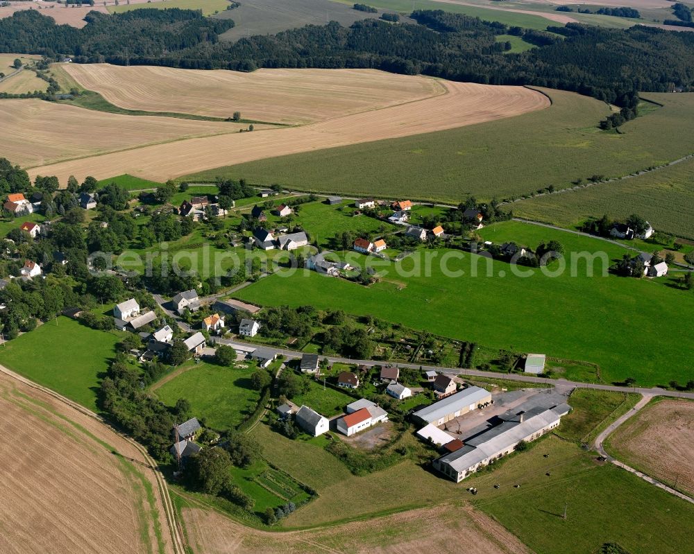 Mobendorf from above - Agricultural land and field boundaries surround the settlement area of the village in Mobendorf in the state Saxony, Germany