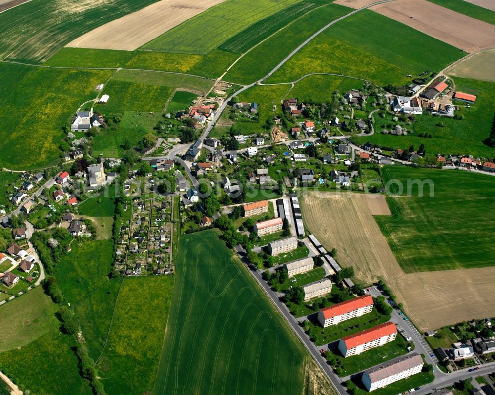 Mohsdorf from the bird's eye view: Agricultural land and field boundaries surround the settlement area of the village in Mohsdorf in the state Saxony, Germany