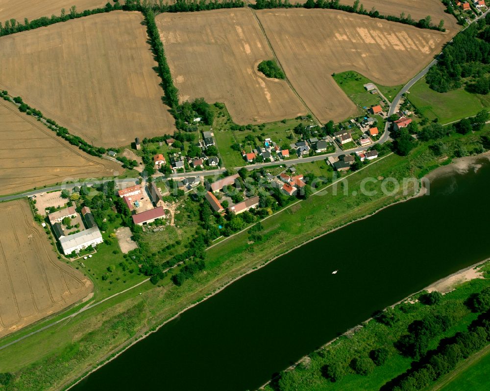 Moritz from the bird's eye view: Agricultural land and field boundaries surround the settlement area of the village in Moritz in the state Saxony, Germany