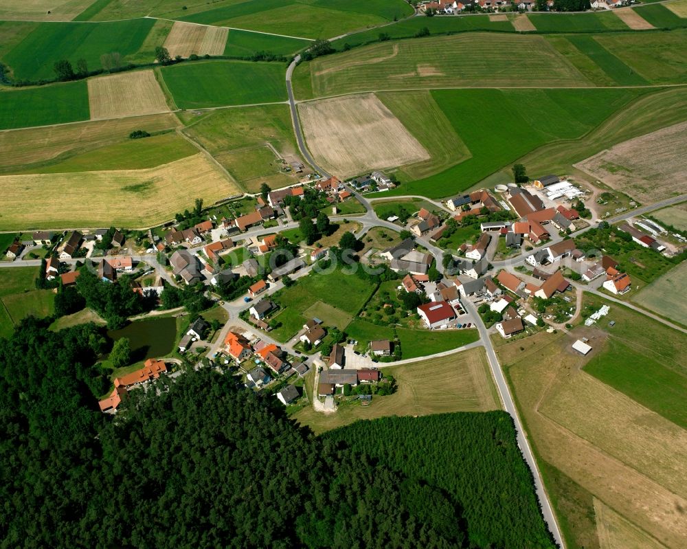 Mörlach from the bird's eye view: Agricultural land and field boundaries surround the settlement area of the village in Mörlach in the state Bavaria, Germany