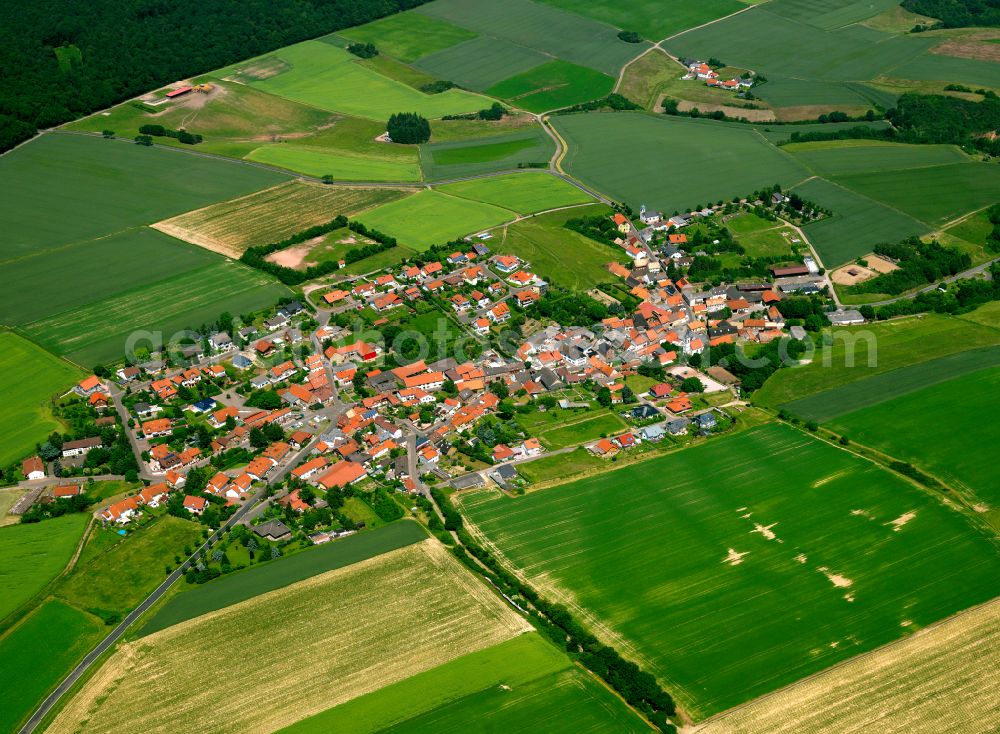 Mörsfeld from above - Agricultural land and field boundaries surround the settlement area of the village in Mörsfeld in the state Rhineland-Palatinate, Germany