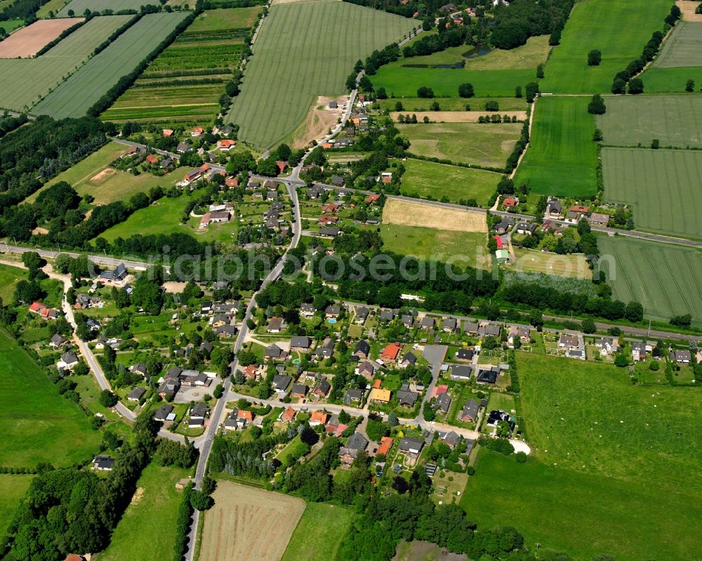 Aerial photograph Müssen - Agricultural land and field boundaries surround the settlement area of the village in Müssen in the state Schleswig-Holstein, Germany